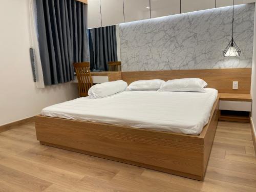 芹苴Căn Hộ Chung cư Hưng Phú的一间卧室配有一张带白色床单的大床
