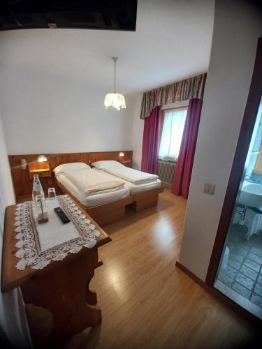 蒂奥内迪特伦托多洛米蒂索恩酒店的卧室配有一张床和一张桌子