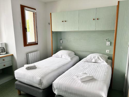 南特赛里斯南特酒店的带镜子的客房内的两张单人床