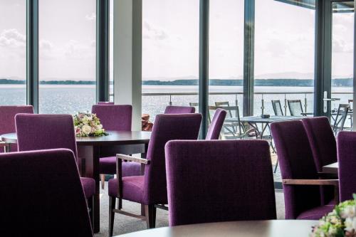 卡鲁扎Hotel Eurobus的配有桌椅并享有水景的客房