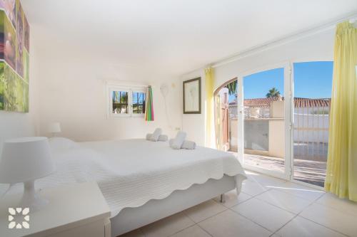 莫莱拉Villa Sol y Sombra by Abahana Villas的白色的卧室设有床和大窗户