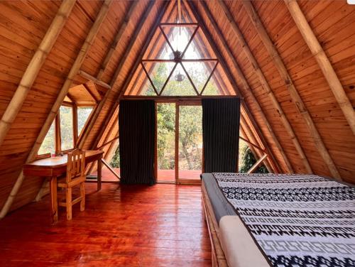 TzununáBeautiful Cabin at Gaia Temple的一间卧室配有一张床和一张书桌
