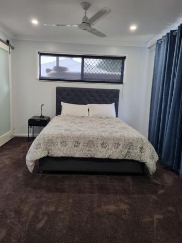 金格罗伊Markwell St Villas的一间卧室设有一张大床和一个窗户。