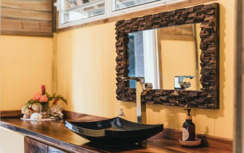 法勒Bungalow Bali Hai的浴室设有黑色水槽和镜子
