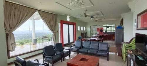 拉瑙Highland Farmhouse Resort的客厅配有椅子和大窗户