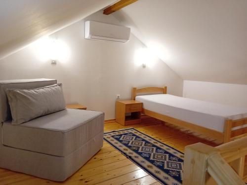 比哈奇Sherwood resort的一间卧室配有一张床、一张沙发和一把椅子