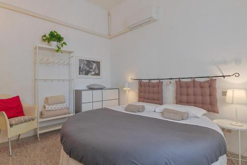 比萨克雷斯提娜斯泰法诺住宿加早餐旅馆的一间卧室配有一张大床和两把椅子
