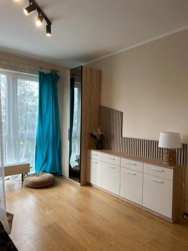 ZvejniekciemsSaulkrastu nams的客厅设有大房间,配以蓝色窗帘