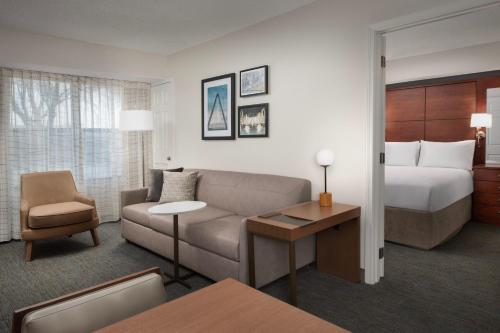 欧弗兰帕克堪萨斯城欧弗兰帕克原住客栈的酒店客房设有一张沙发和一张床
