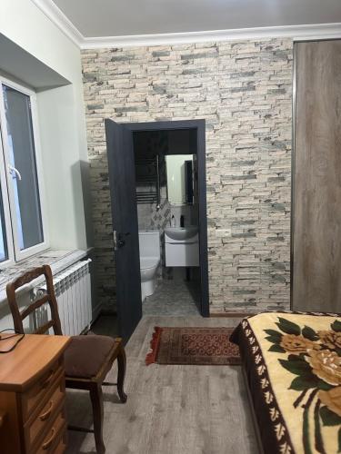 ZarritʼapʼZaritap Guest House的一间卧室,带石墙的浴室