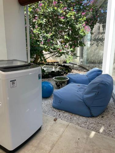 金巴兰New Kuta Suites的冰箱旁的蓝色豆袋椅