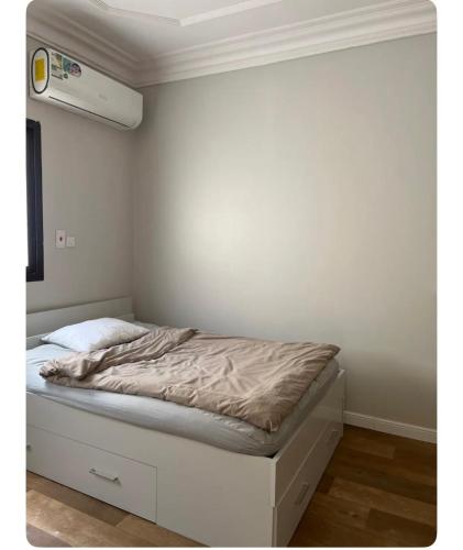 利雅德غرفة بحي القدس بحمام مشترك的白色墙壁间的一张床位