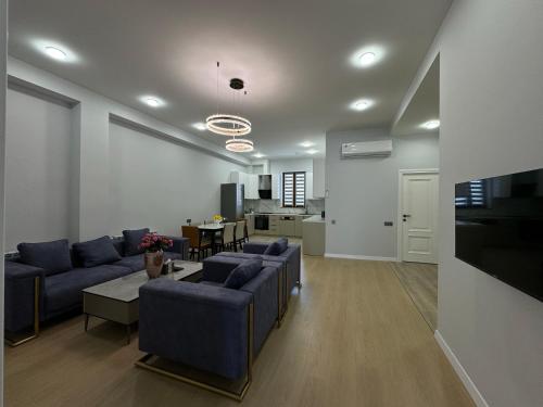 埃里温GS Premium的一间带蓝色沙发的客厅和一间厨房