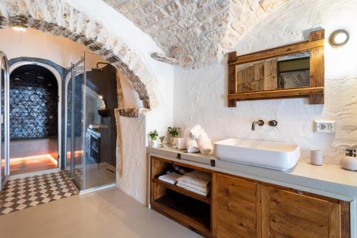 普蒂尼亚诺Trulli Tower的一间带水槽和淋浴的浴室