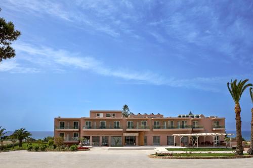 马斯蒂查里Ammos Luxury Resort的一座大建筑,前面有棕榈树