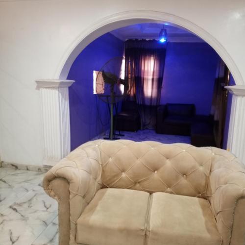 IkoroduJ Lounge的客厅设有一张沙发,客厅设有蓝色的墙壁