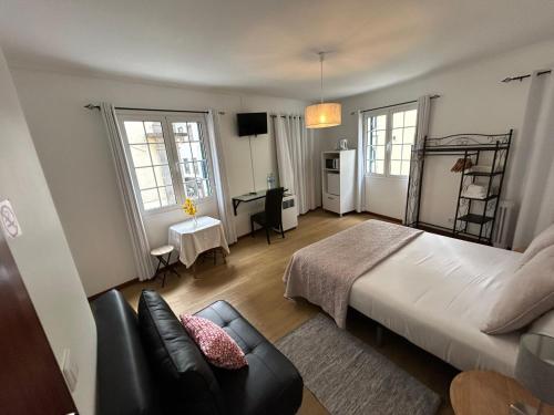 丰沙尔Palmar Rooms的一间卧室配有一张床和一张沙发