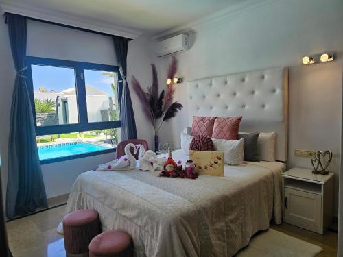 普拉亚布兰卡VILLA KARLA的一间卧室设有一张大床和大窗户