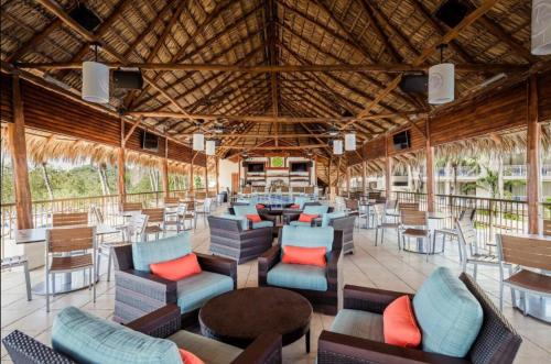 普拉亚弗拉明戈Margaritaville Beach Resort - Honeymoon suite - Costa Rica的一间带桌椅和大型天花板的餐厅