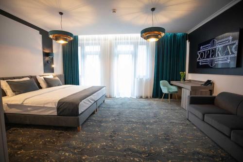 蒂米什瓦拉Opera Hotel的一间卧室配有一张床、一张沙发和一张书桌