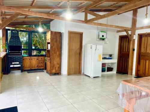 南圣弗朗西斯科Suítes Recanto Monte trigo的厨房配有白色冰箱和木制天花板