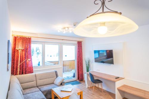 上陶恩alpsrental Apartments Freja Obertauern的客厅配有沙发和桌子