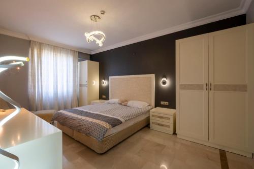 阿拉尼亚Goldcity Otel Kargıcak的一间卧室设有一张床和黑色的墙壁