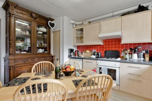 Horsell30 Woodlands的厨房配有带椅子的木桌和桌子。