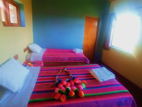 普诺TITICACA'S SALA UTA的一间设有两张床的客房,床上备有水果
