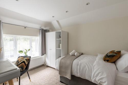 StoughtonFlat in Guildford的白色的卧室设有床和窗户
