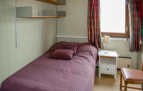 Magnor2 Bedroom Stunning Home In Skotterud的卧室内的紫色床,带窗户