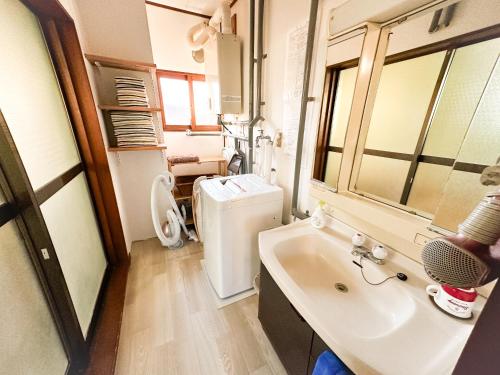 白老町Chano Onsen House 温泉付き的一间带水槽和冰箱的浴室
