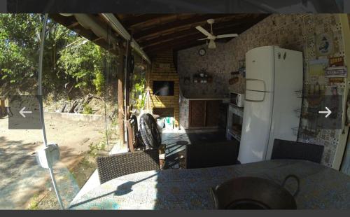 伊图Chalé no Camping Carrion próximo a Tomorrowland的厨房配有冰箱和桌椅