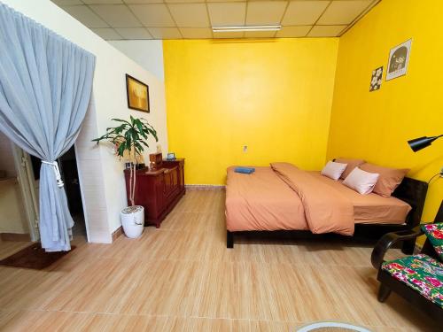 吉婆岛Tiny House Cat Ba的一间卧室设有一张床和黄色的墙壁