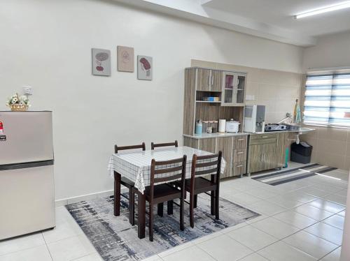 亚娄SAFRA HOMESTAY PERLIS的厨房配有桌椅和冰箱。
