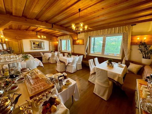 绍萨尔地区基策克斯特瑞尔兰德全景酒店的用餐室配有白色的桌子和白色的椅子