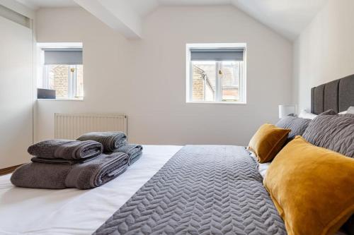 伦敦2BD Mews House, Wanstead的一间卧室配有带毛巾的床