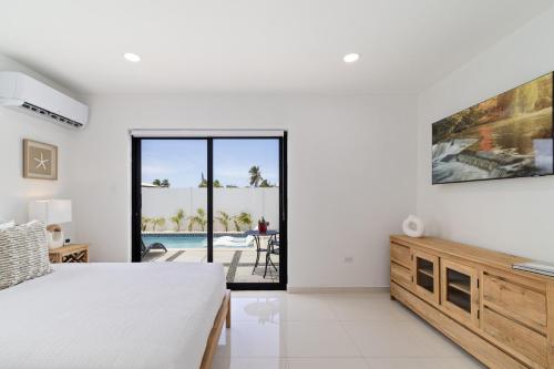奥拉涅斯塔德Tanki Leendert 43K的一间卧室配有一张床,享有游泳池的景色