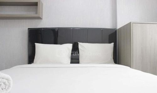 万隆Boboroom的一张配有白色床单和枕头的大床