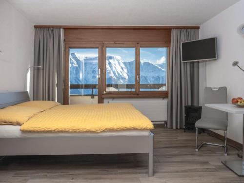 利德阿尔卑斯Apartment Appartementhaus Zurschmitten 15 by Interhome的一间卧室设有一张床和一个享有山景的窗户。