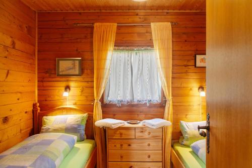 格赖瑙Grashäusl的小木屋内一间卧室,配有两张床