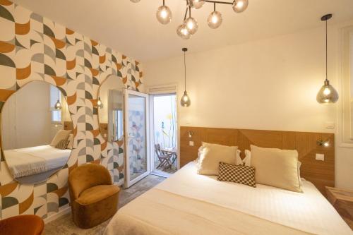 比亚里茨Hôtel Barnea的配有一张床和一把椅子的酒店客房