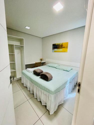加拉尼温斯Flats Manoel Tavares 102的一间卧室配有带毛巾的床