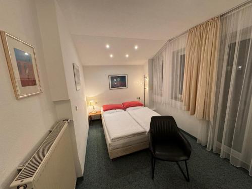 慕尼黑Hotel Occam的一间酒店客房,配有一张床和一把椅子