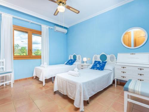Son SardinaEs Garroveret - Villa With Private Pool Free Wifi的蓝色的客房设有两张床和窗户。