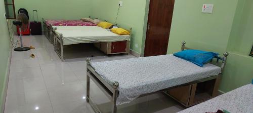德奥加尔Anand Bhavan的一间客房内配有两张床的房间