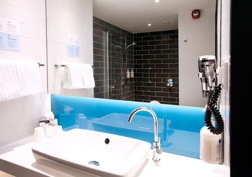 杜塞尔多夫Holiday Inn Express - Düsseldorf Airport的一间带水槽和镜子的浴室