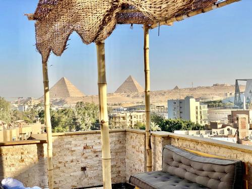 开罗Three pyramids view INN的金字塔阳台伞下的椅子