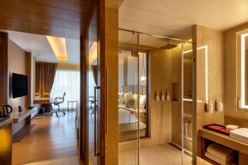 马杜赖Grand Madurai by GRT Hotels的一间带玻璃淋浴和水槽的浴室