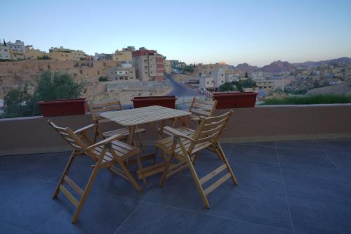 瓦迪穆萨Petra Plaza Hotel的美景阳台配有桌椅